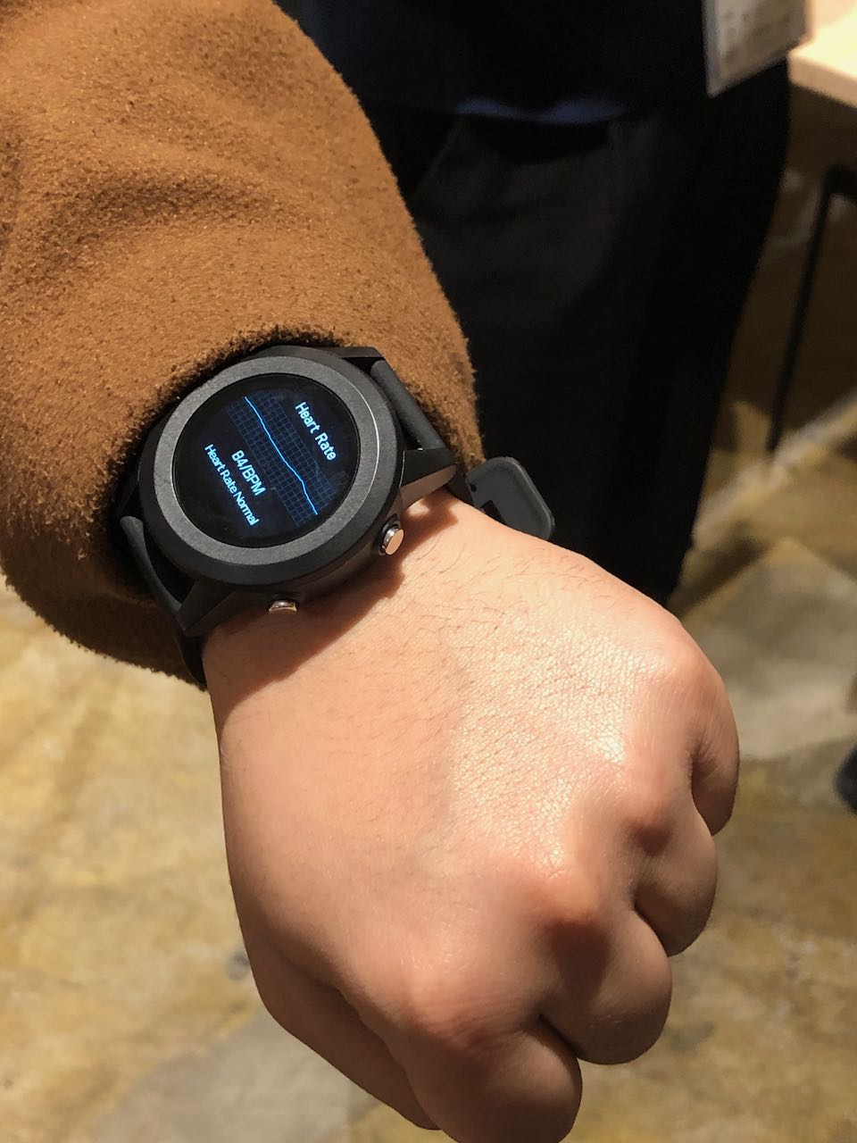 A Gunma University student shows off a LoRaWAN wristwatch that they are intending to use for an elder care application in Ota City